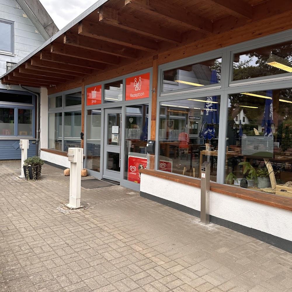 A building with a reception, shop and large windows.